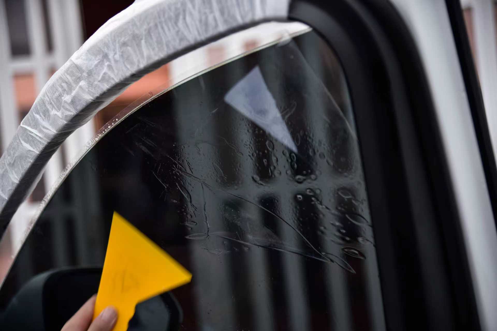 Close-up of tint film edge finishing on side glass