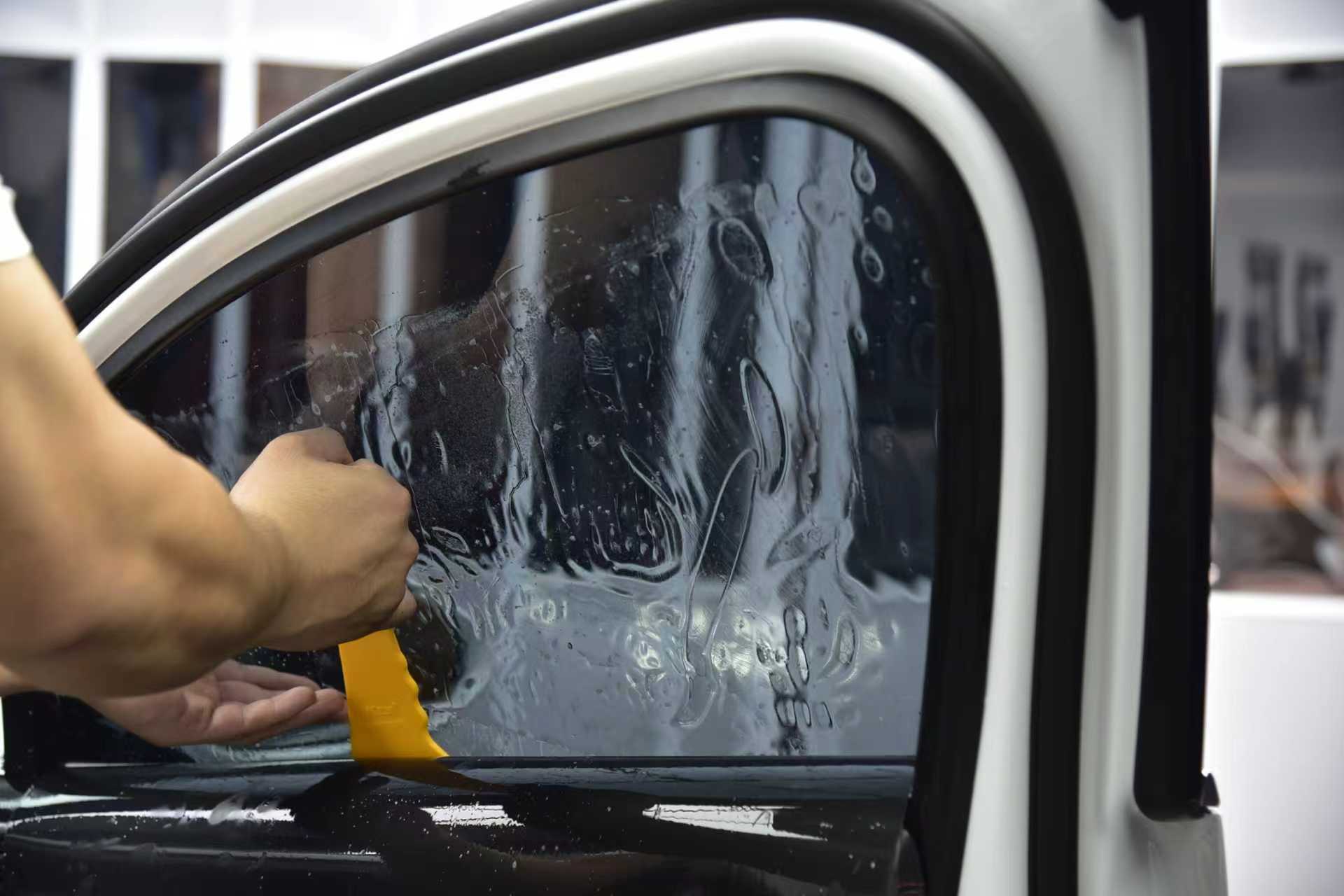 Tint film being formed and worked into a side window
